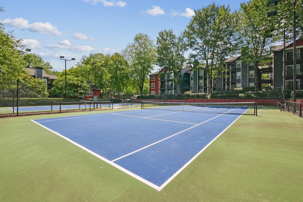 Tennis Court A tennis court surrounded by trees and buildings at Elme Druid Hills, Atlanta, Georgia